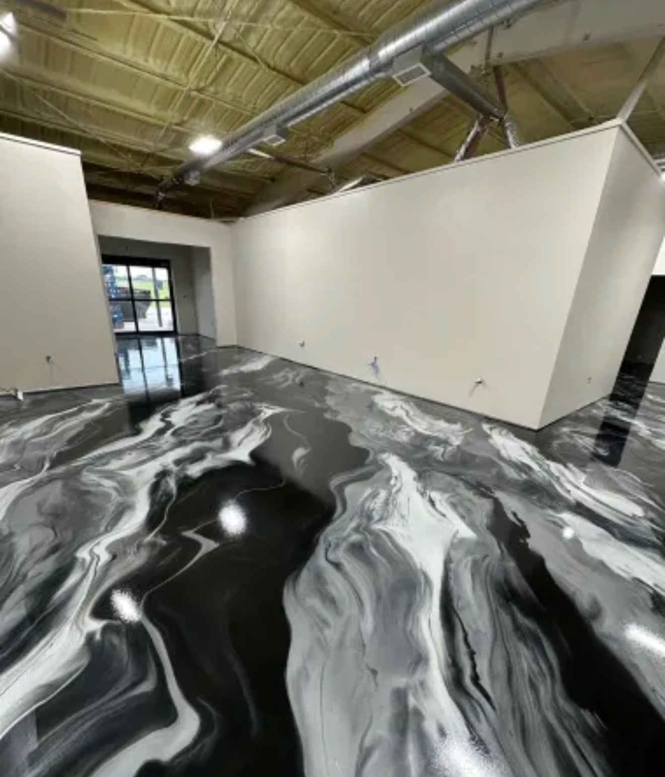 Showroom floor — custom metallic epoxy swirl finish
