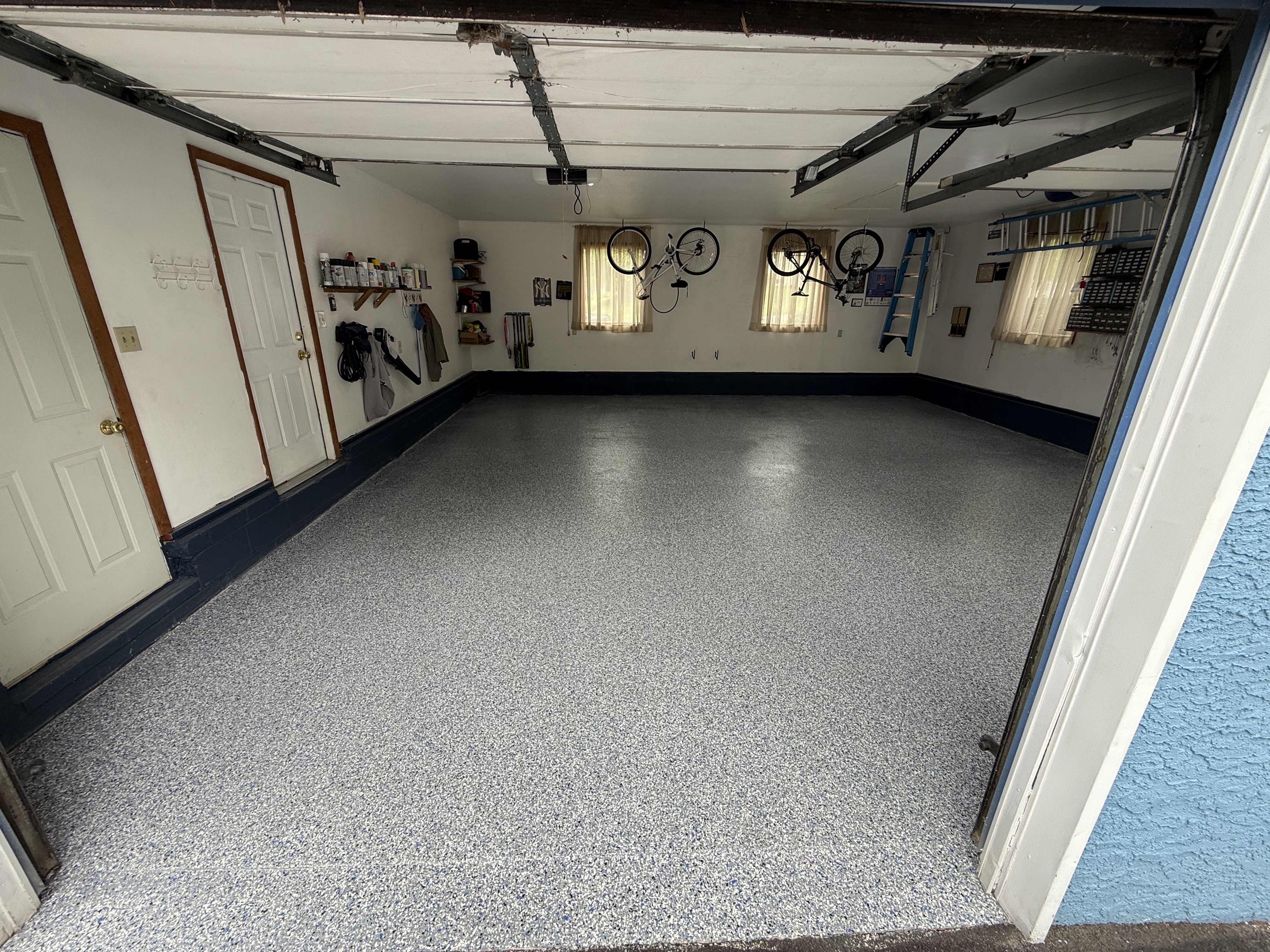 Garage floor — blue/gray full-flake broadcast with polyaspartic topcoat