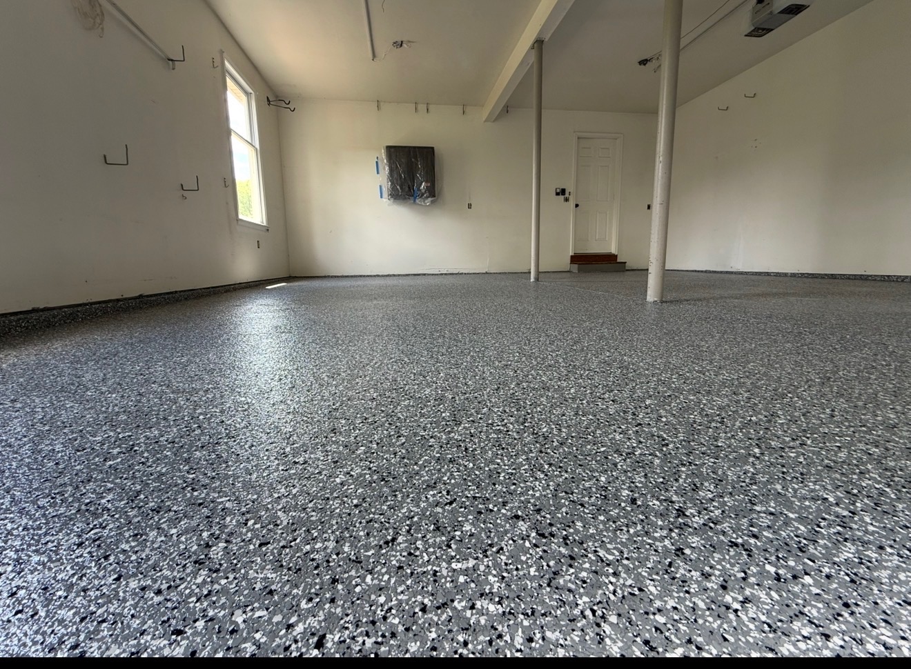 Two-car garage — dark gray full-flake broadcast, polyaspartic finish